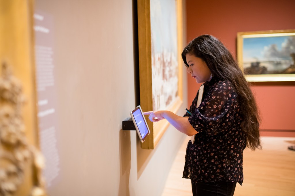 Girl using touchscreen in museum exhibit